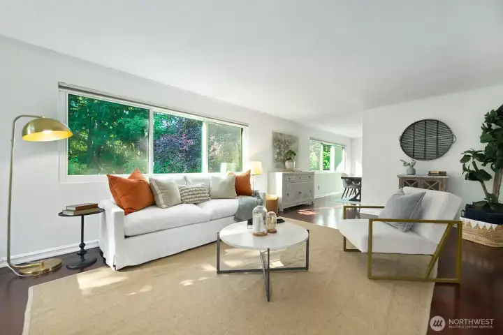 Dark wood floors extend to formal dining room adjacent to the living room.