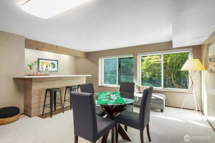 A bar, new carpet and paint, wood burning stove and great light enhance this space.