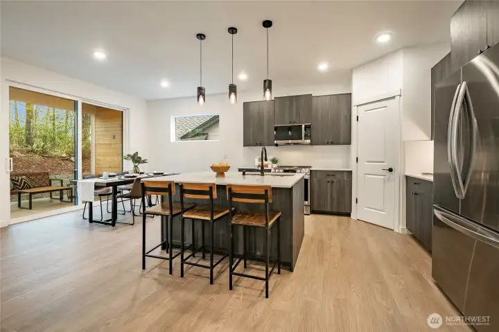 Modern Kitchen with upgraded appliances, backsplash, and walk in pantry.