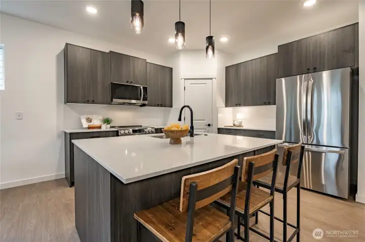 Modern Kitchen with upgraded appliances, backsplash, and walk in pantry.