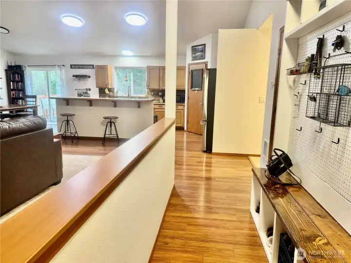 The entry walkway with the living room on the left, and the kitchen straight ahead.