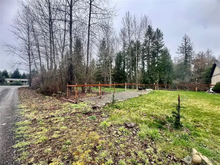 The property to the side of the home, from the street.