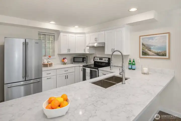 Quartz countertops with large eating bar. Window for fresh air.