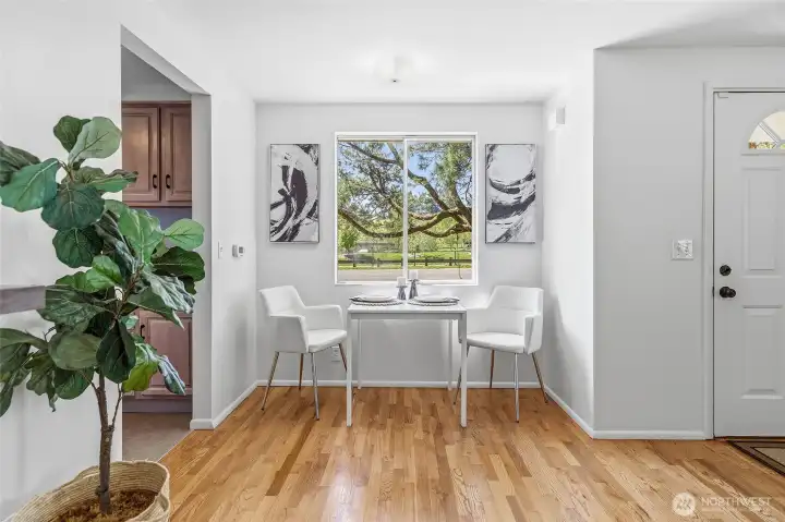 Formal living room with a wood burning fireplace, hardwood floors and opens to the dining area with views of Cromwell Park and light and bright western exposure