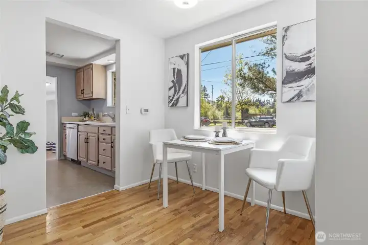 Formal living room with a wood burning fireplace, hardwood floors and opens to the dining area with views of Cromwell Park and light and bright western exposure