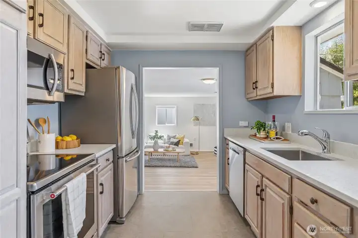 Updated galley style kitchen with quartz counters, refaced cabinets and stainless appliances opens to family room and to the dining area/living room.