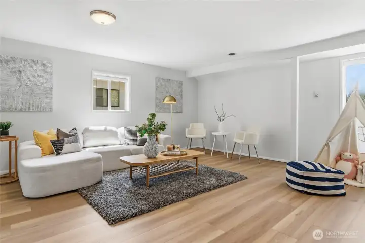 Spacious family room with luxury vinyl plank flooring, sliding door to back yard and back patio.  Barn door to updated 3/4 bathroom and laundry room.