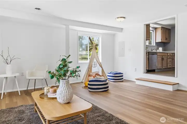 Spacious family room with luxury vinyl plank flooring, sliding door to back yard and back patio.  Barn door to updated 3/4 bathroom and laundry room.