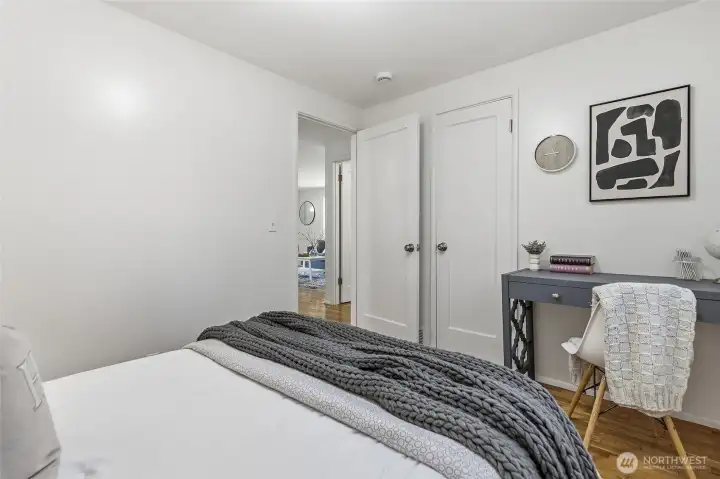 Main floor bedroom #2 with hardwood floors and views out to the backyard.