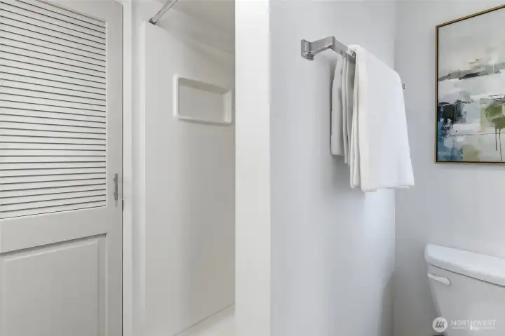 Main floor remodeled 3/4 bathroom accessed view sliding barn door from the family room with a stack washer and dryer.