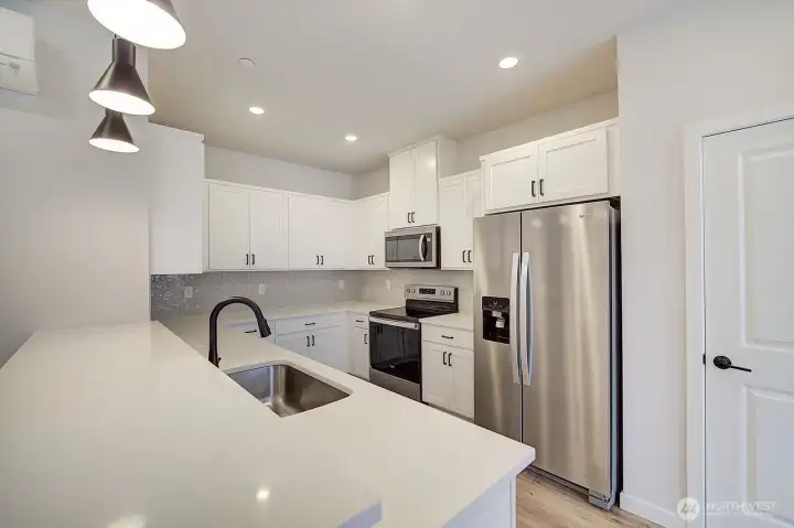 Lovely quartz counter tops with inset stainless steel sink. All appliances included!