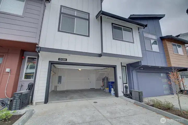 Back of the home with remote garage door.