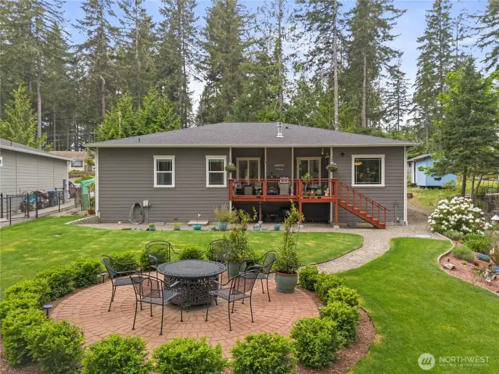 Back of the home showcasing the entertaining space and grassed yard