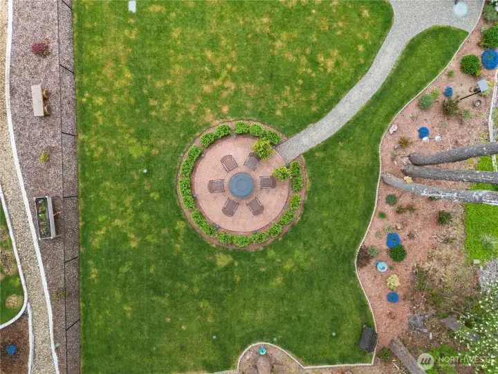 Birds eye view of the backyard design. Fire place does not convey.