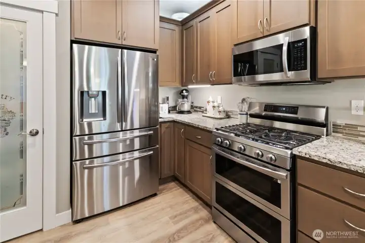 Kitchen with all stainless steel appliances - double oven and a walk-in pantry.