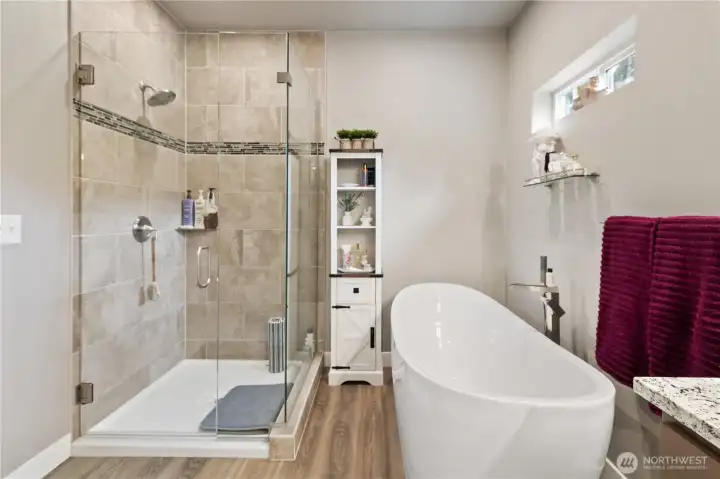 Glass shower and soaking tub.
