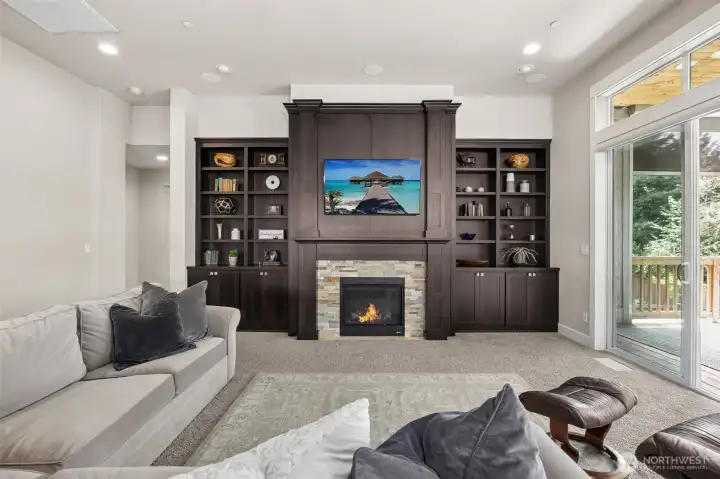 Rich built ins surround the living room gas fireplace