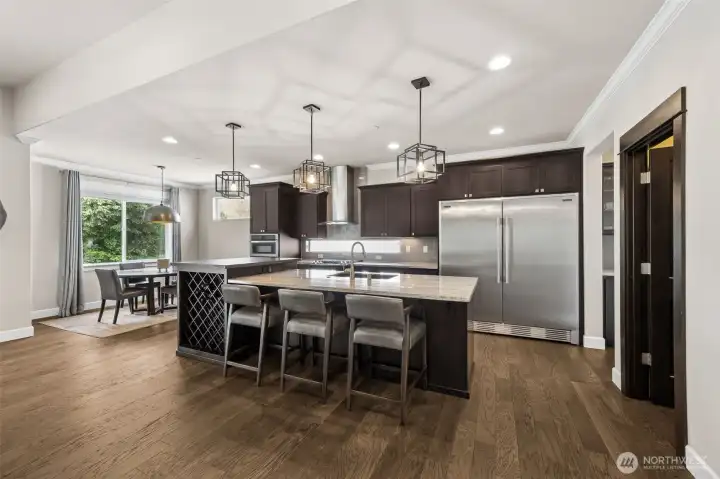 Warm hardwood floors give way to off kitchen eating nook overlooking the back yard