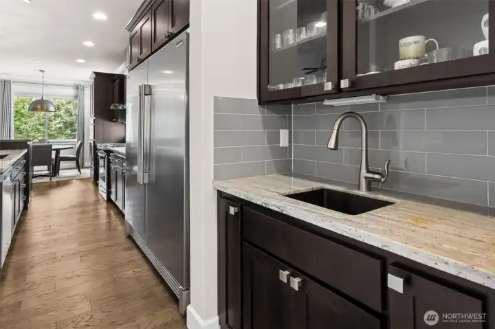 Butler's pantry divides the kitchen with the grand dining room just off the foyer