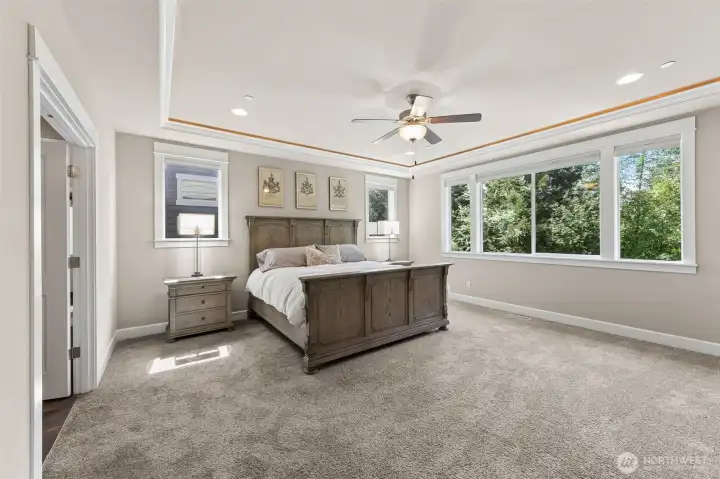 Primary suite with inlay lighting and wall to wall carpet
