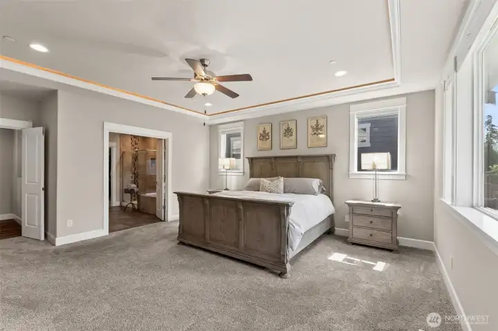 Full bath just off primary suite- french doors lead into the bedroom and another set lead to the bathroom