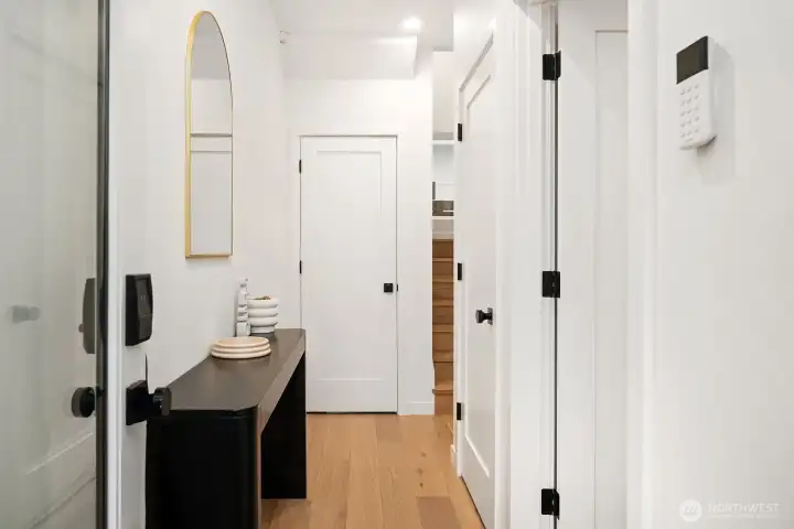 Bright and functional entry level with engineered hardwood floors, a stylish vanity, and a clean modern layout that sets a polished tone from the moment you arrive.