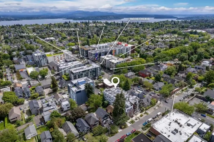 This aerial view highlights the home's prime location between Capitol Hill and the Central District, with sweeping views of the surrounding neighborhood and Puget Sound beyond.