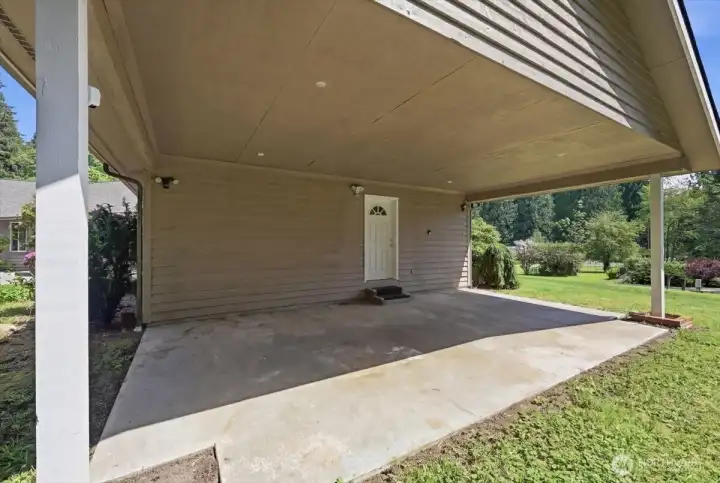 Car port off the bedroom with the exterior door.