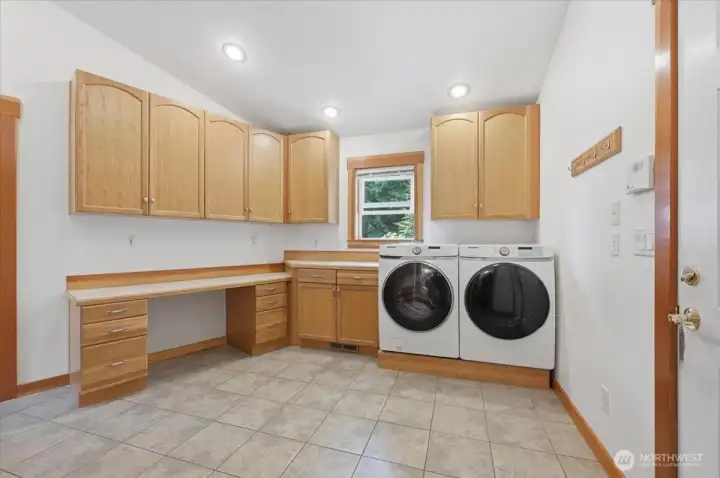 Large laundry/mud room  with desk area.