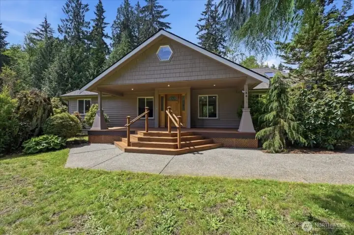 Step up to the home on the porch looking out to your garden and fruit trees