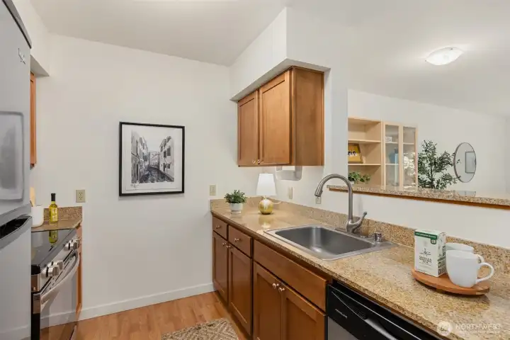 Solid granite slab countertops and open to the dining room for ease in entertaining. Solid granite slab countertops and open to the dining room for ease in entertaining.
