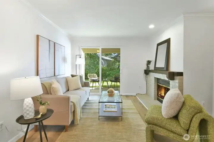 Cozy living room featuring a wood-burning fireplace and sliding glass doors that open to a private patio.