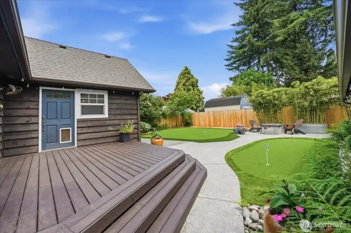 Composite deck leading to backyard oasis.