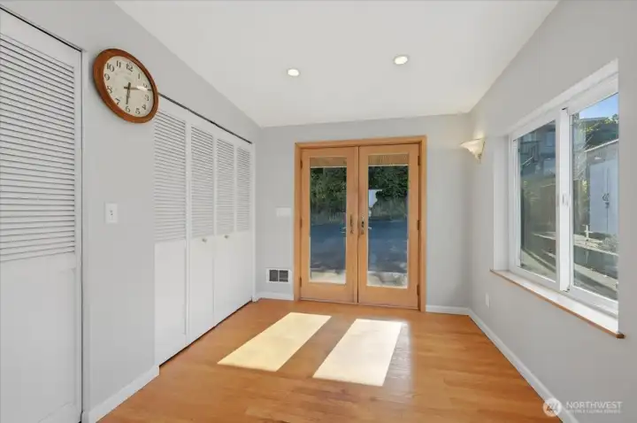 As you enter the home you are welcomed by French doors that lead into a foyer with hardwood floors and a handy drop zone closet for coats and shoes.