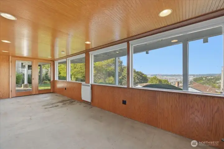 What a great space with rich wood accents to turn into sunroom, fitness room or whatever your needs.
