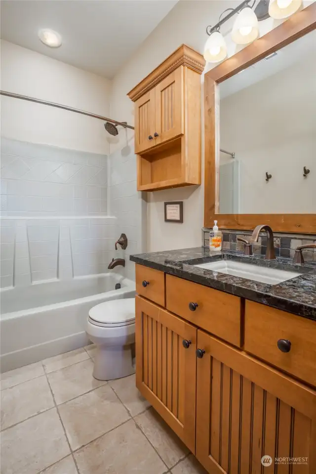 A granite countered and tile floor (with radiant heating) full bath; three of the bedrooms have an attached full bath on suite