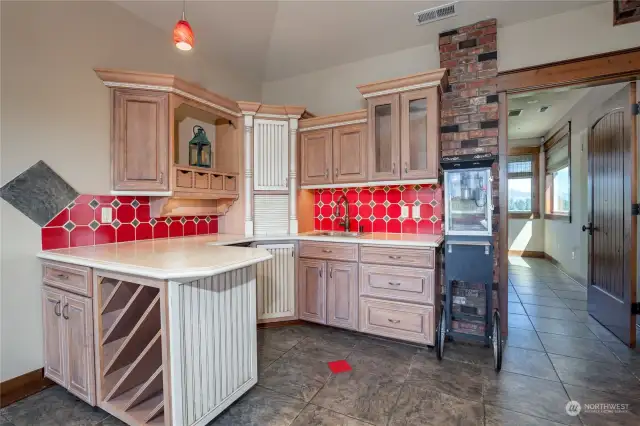 The bonus room kitchen area, with cabinets and a wine storage rack