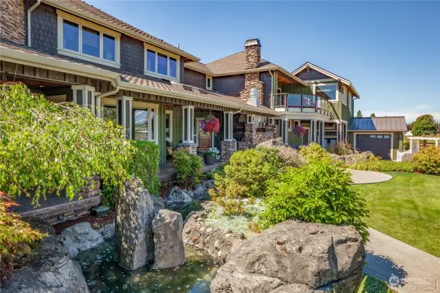 A view from the rear of the property, with custom walkways and an extensive water feature