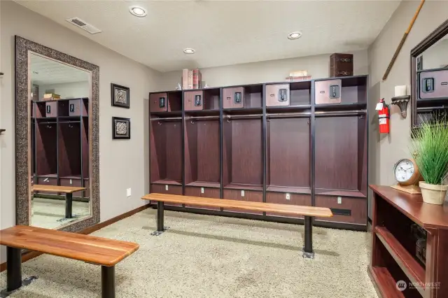 The groom's suite's sitting and locker area, with carpet flooring and recessed can lighting