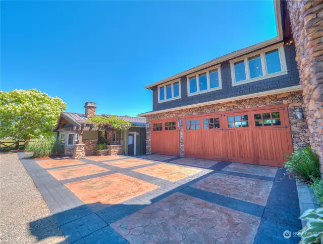 The home features extensive garage spaces, with both front and rear garage doors for both garages, capable of 10 car indoor storage, and there is extensive off-street parking both in front of the residence and in an adjacent gravelled lot.  The main garage features overhead heating and Sonos In Home audio sound