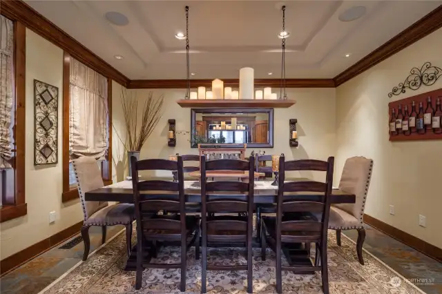 The formal dining room continues with the slate flooring, and has a terraced coved ceiling