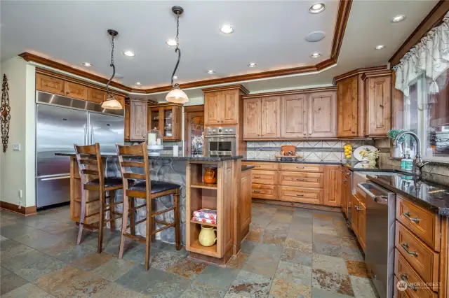 Another kitchen view; notice the coved ceiling with recessed can lighting and the art lighting fixtures