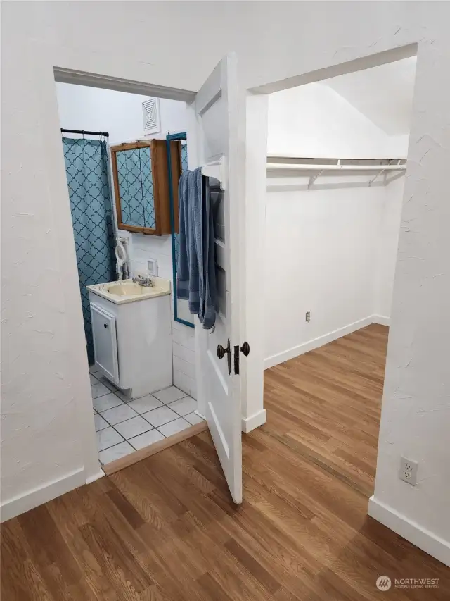 Primary bedroom with bath and walk-in closet