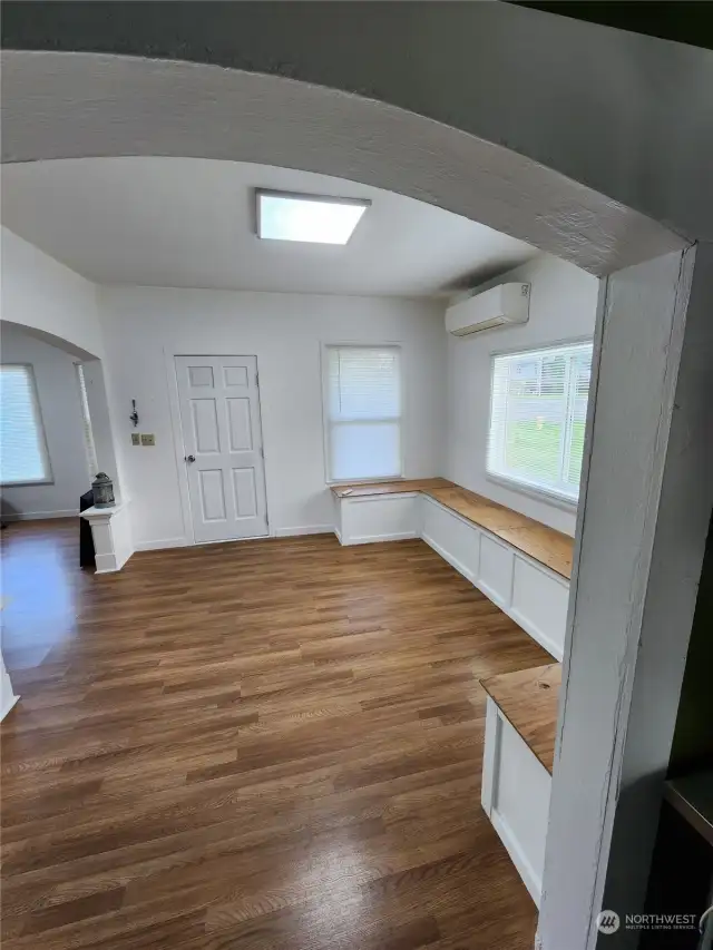 Living, dining, and kitchen connected by beautiful archways