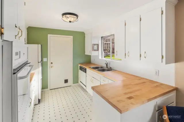 Light, bright kitchen with restored original cabinets & new butcher block countertops