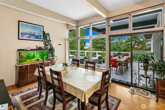 Wrapped in clerestory windows and a full glass wall that opens to the Covered Deck, the Dining Room blurs the line between indoor ritual and outdoor reverie. Light pours in from three sides, animating exposed beams and warm wood floors—an inviting space for weekday meals or celebratory feasts beneath shifting skies.