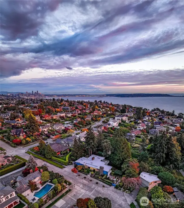 Sweeping east toward the city, this aerial reveals 4221 W Armour’s rare perspective: nestled within Magnolia’s verdant hillside, with the Seattle skyline, Queen Anne ridge, and Cascade Range in layered succession beyond. At sunrise, the home catches the first light of day—an urban sanctuary positioned perfectly between nature and metropolis.