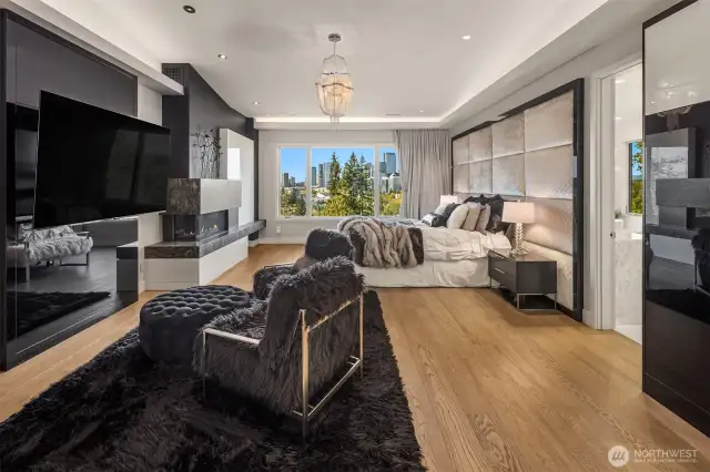 The primary suite is elegant and elevated. Beautiful city views, elegant draperies, wet bar and fireplace set the mood for relaxation.