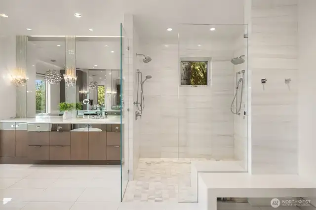 Spa inspired bathroom with walk in shower, dual vanities, makeup vanity and freestanding soaking tub with floor accent lighting. Truly a Masterpiece.