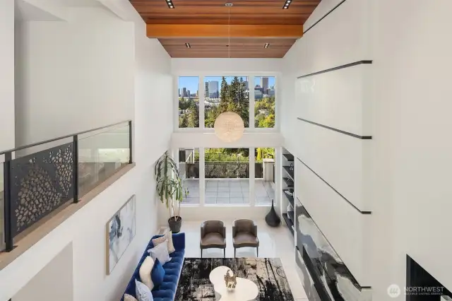 The formal living room offers great views and a contemporary fireplace with custom art niches and shelving.